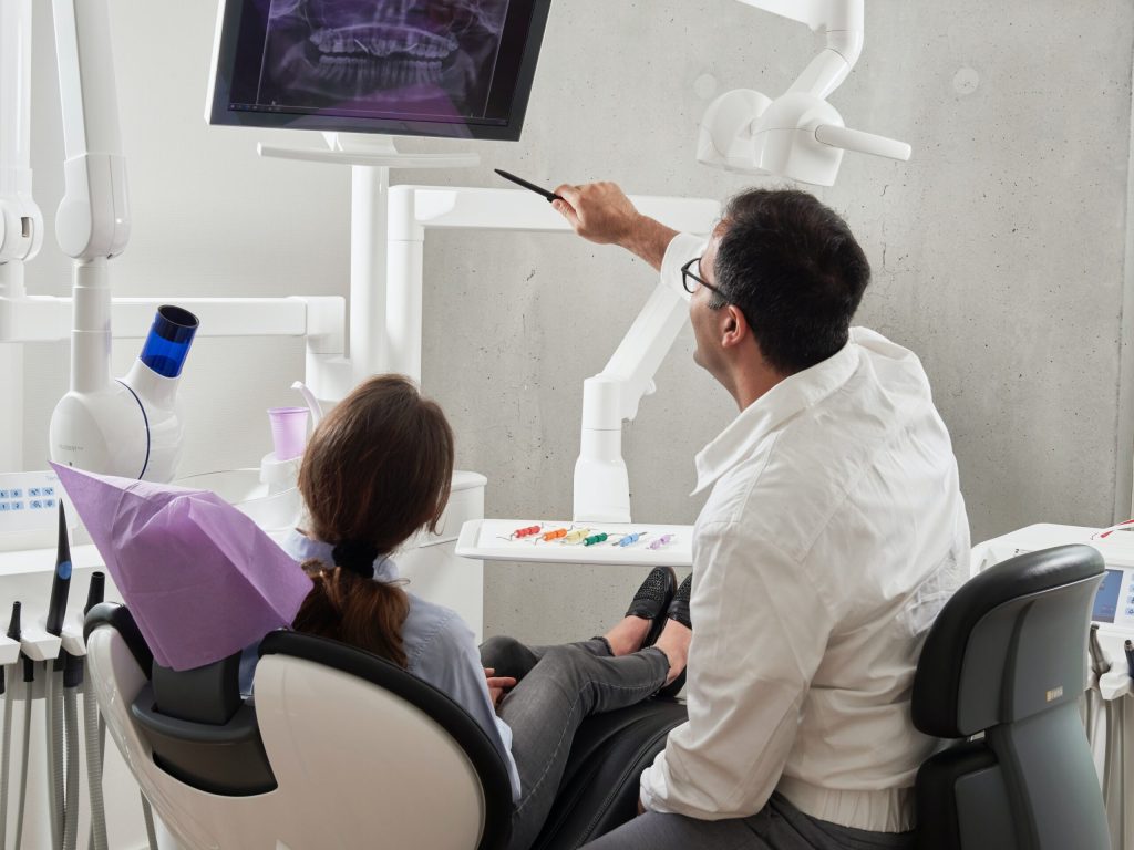 dentist and patient watching a radiography