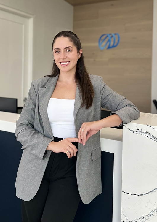 Female dental professional leaning on counter