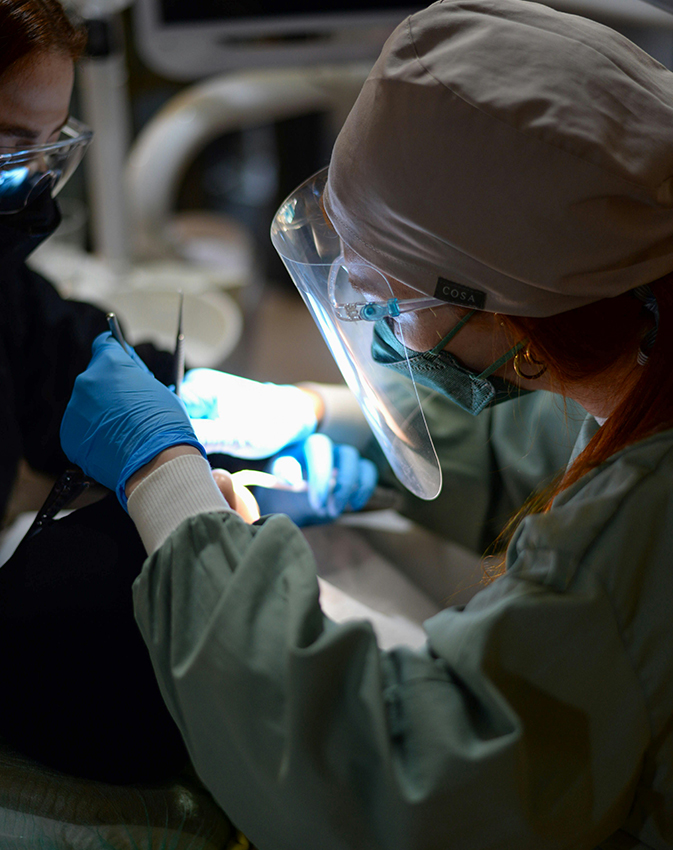 Dentist performing dental treatment under light