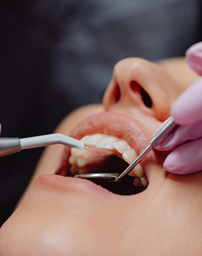 Dentures held in gloved hands