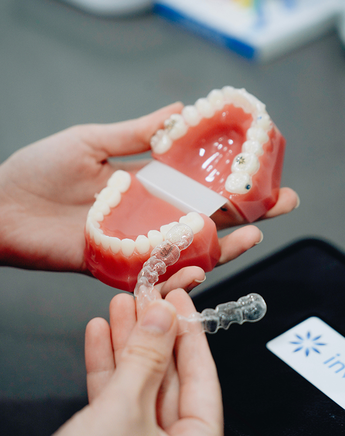 Dentures being adjusted by dental professional
