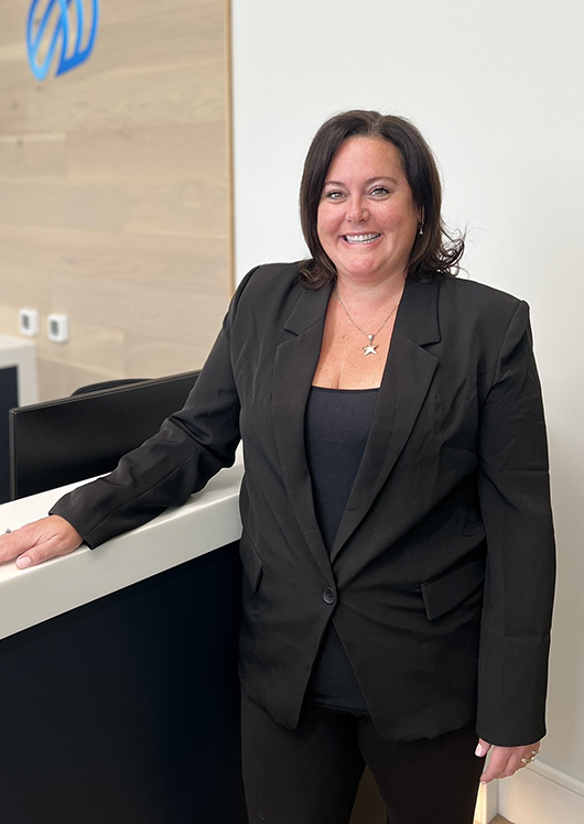 Female dental professional standing at reception