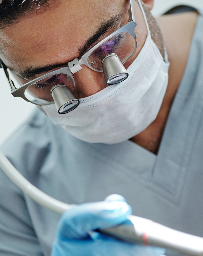 Dentist wearing magnification glasses during procedure