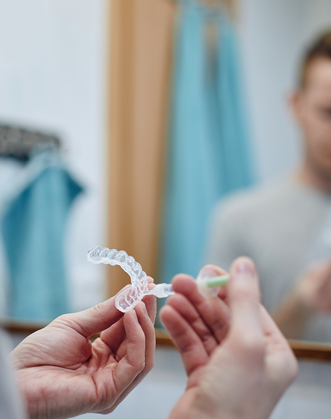 Dental professional holding tooth shade guide