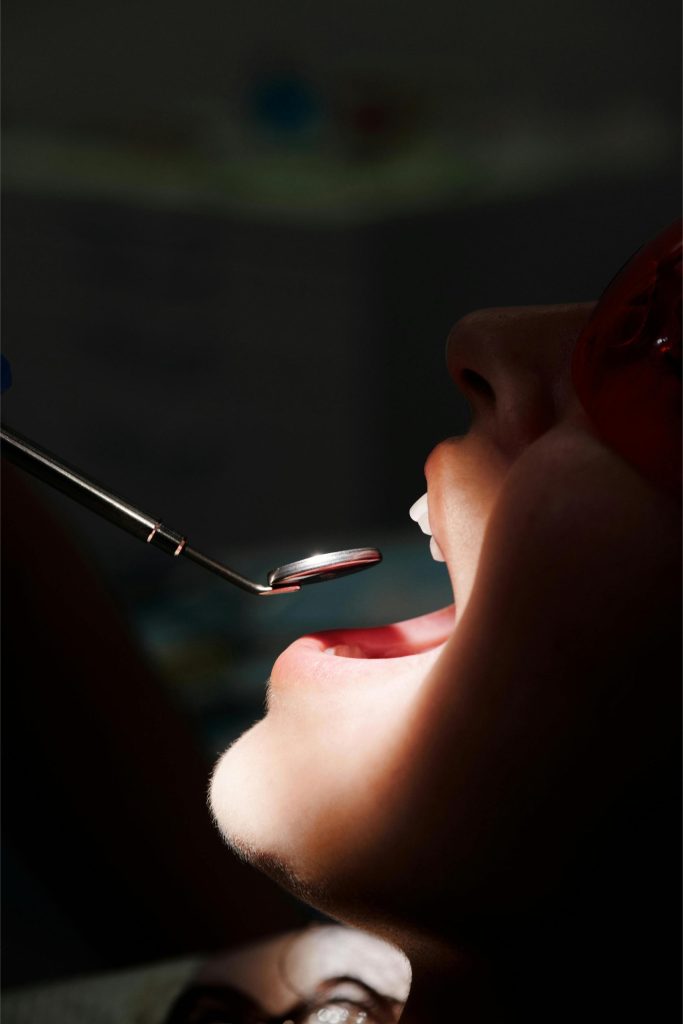 Close-up dental procedure with lighting and precision tools