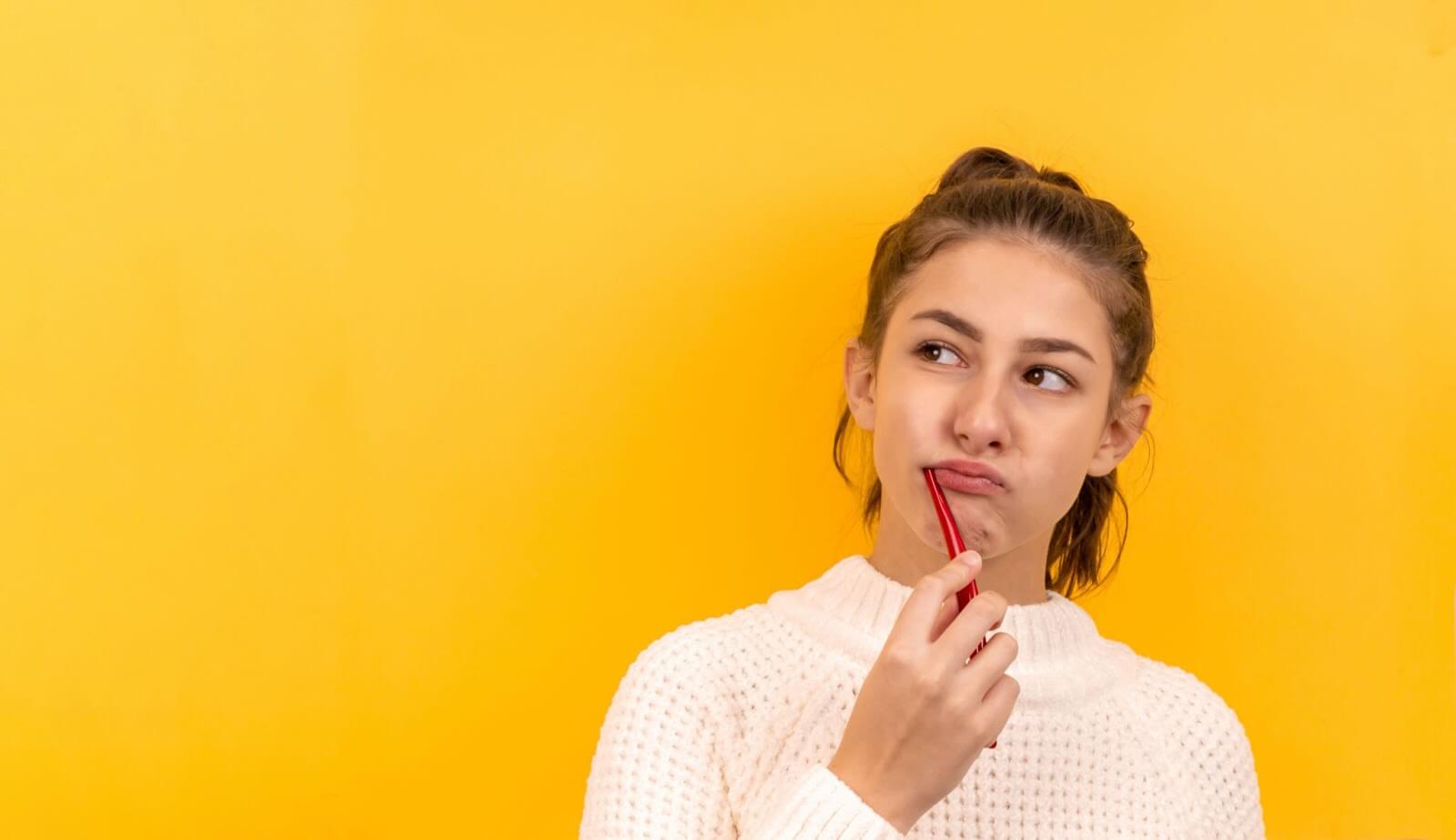 a woman with a tooth brush in her mouth