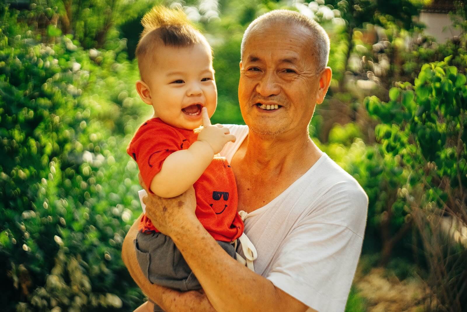 a grandfather holding his grandson