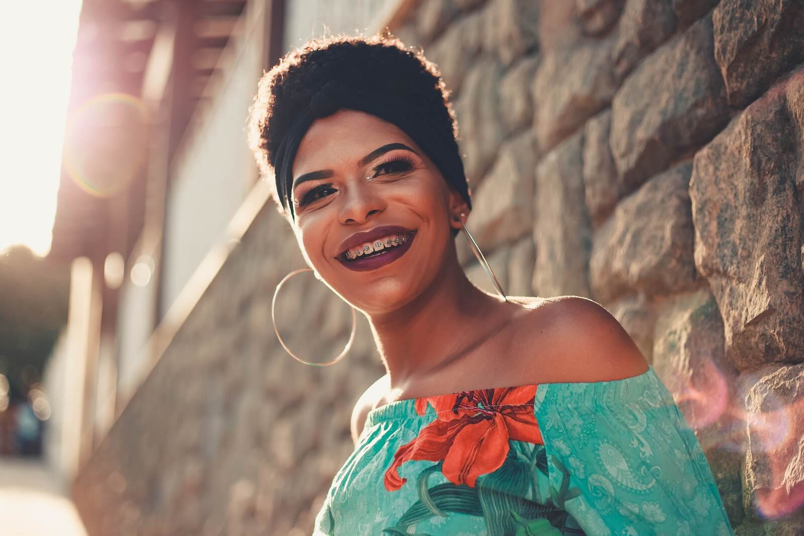 a woman with short hair smiling with braces