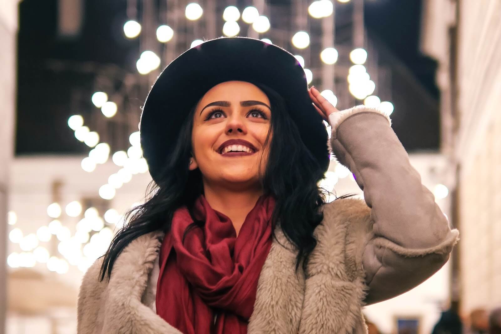 a woman smiling and looking off screen